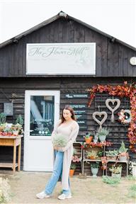 The Flower Mill Owner Kirsty standing outside the flower studio at Trumpetons Farm in Bedfordshire. What started out as a small florist shop has flourished into a thriving florist studio at Trumpetons Farm in Thorncote Green offering flower bouquets delivered locally, personal funeral flower arrangements, a whole range of floristry workshops through out sister company The Bedfordshire Flower School and timeless wedding flowers.